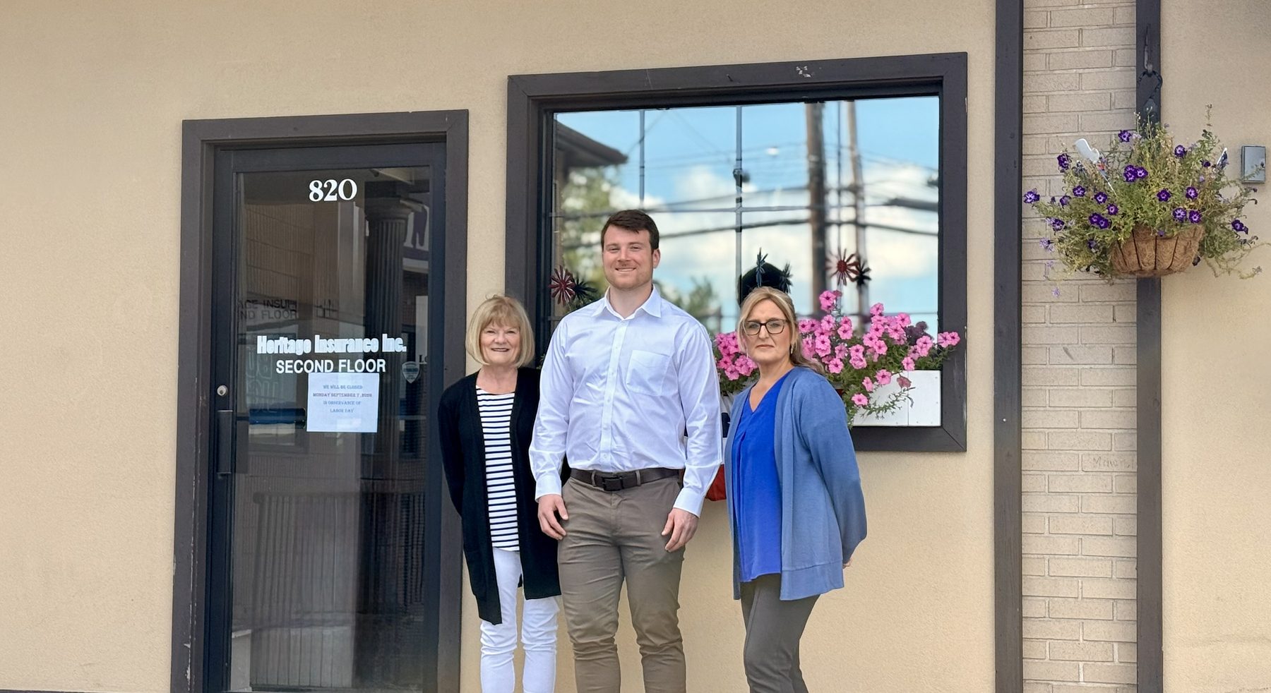 Noah Rak, Angela Mancini and Theresa Musso outside the Heritage Insurance office in Waterbury